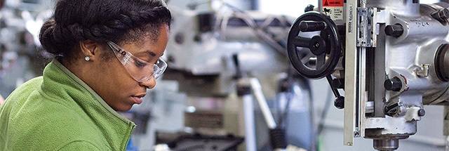 black female working with mechanical equipment