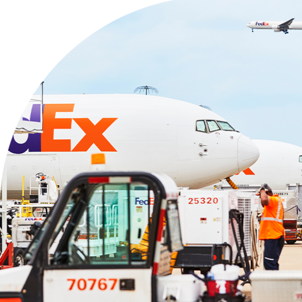 image of fedex planes and workers near runway at hub