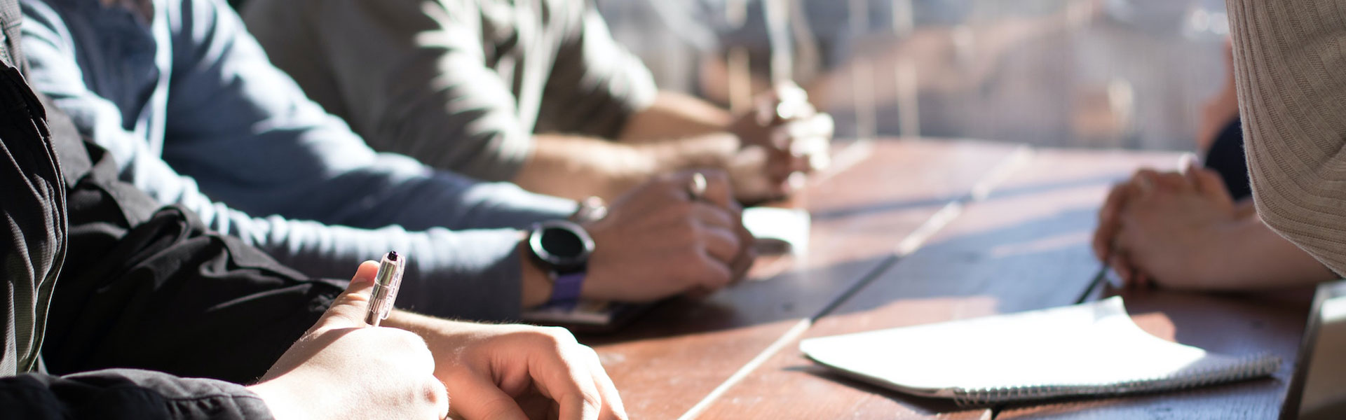 view of hands at conference table