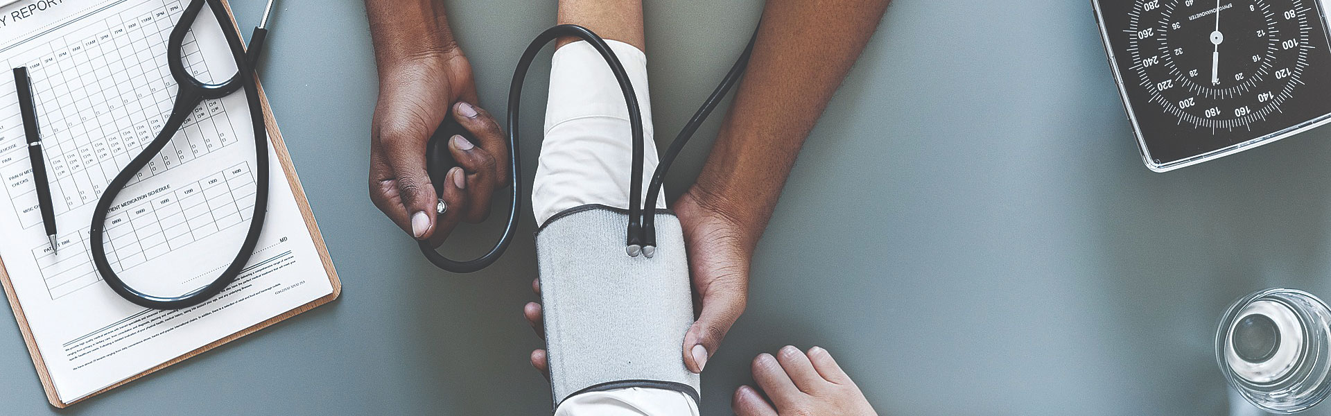 physician and patient hands taking blood pressure