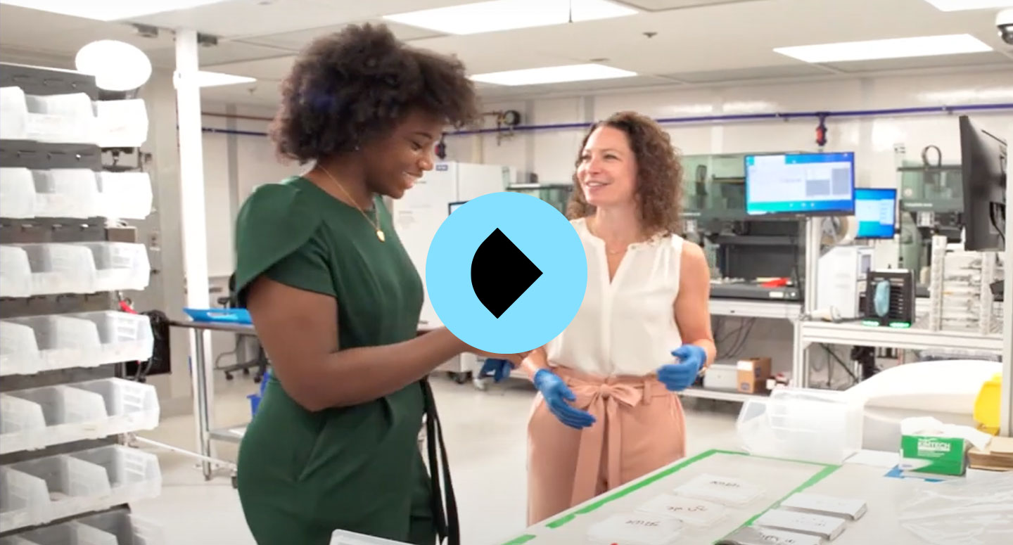 two women talking in lab